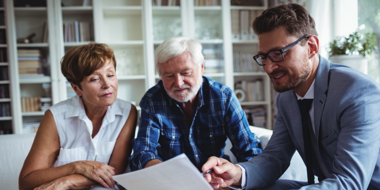 Senior couple planning their investments with financial advisor